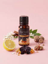 Olejek zapachowy do świec Black Orchid & Amber w butelce 10 ml otoczonej czarną orchideą, bursztynem, drewnem sandałowym, jaśminem, cytryną i gałką muszkatołową