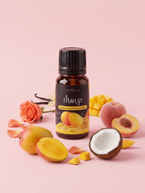 Olejek zapachowy do świec Mango w butelce 10 ml otoczonej mango, brzoskwinią, połówką kokosa, pąkiem róży i laskami wanilii